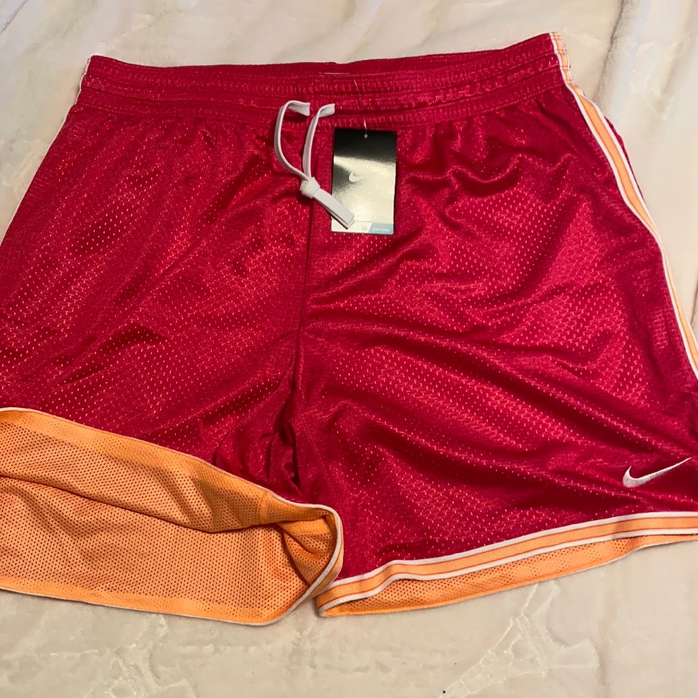 Nike Women’s Shorts are a  redish/pinkish color hard to explain. Beautiful color